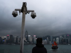 FILE - Surveillance cameras are seen as a visitor looks at Victoria Harbour in Hong Kong, Monday, March 11, 2024. The president of U.S.-funded Radio Free Asia said its Hong Kong bureau has been closed because of safety concerns under a new national security law, deepening concerns about the city's media freedoms. Bay Fang, the president of RFA, said in a statement Friday March 29, 2024 that it will no longer have full-time staff in Hong Kong, although it would retain its official media registration.
