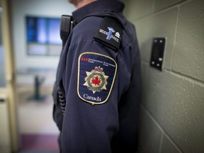 Patches are seen on the arm and shoulder of a corrections officer in Abbotsford, B.C., on Thursday Oct. 26, 2017.