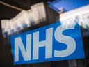 (FILES) A photograph taken on January 10, 2024 shows the logo of the NHS (British National Health Service), in Bracknell. Health care for children and young people grappling with gender identity issues should exercise