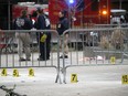 Police inspectors gather evidence around a park outside of Manhattan Criminal Court