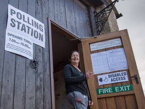 A voter leaves a polling station located in the Tithe Barn in the village of Mells on May 7, 2015, in Somerset, England. All U.K. expats will be eligible to cast a ballot at the next general election.