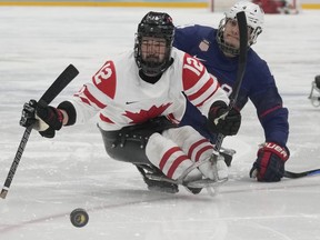 The Canadian team attempting to reclaim a world para hockey championship on home ice was announced Thursday by Hockey Canada. Greg Westlake, left, of Canada and Brody Roybal of the United States battle for the puck during their para ice hockey finals match at the 2022 Winter Paralympics in Beijing, Sunday, March 13, 2022.