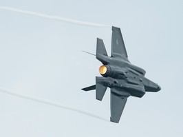 An F-35A Lightning II fighter jet in the air.