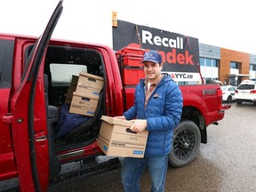 Landon Johnston unloads some of the boxes with petitions to recall Mayor Jyoti Gondek at the Elections Office in Calgary on Thursday, April 4, 2024.