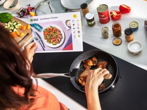A person cooking using a Hello Fresh meal delivery kit
