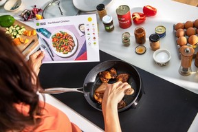 A person cooking using a Hello Fresh meal delivery kit