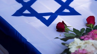 A coffin draped with the Israeli flag.