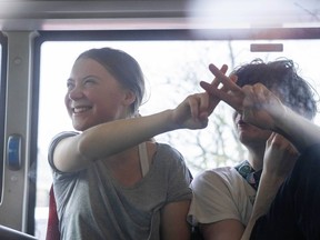 Climate activist Greta Thunberg flashes a V-sign