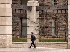 A person walks past University of Toronto signage, Tuesday March 26, 2024.