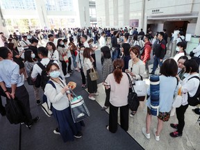 People gather in the lobby of a Taipei office building after an earthquake.