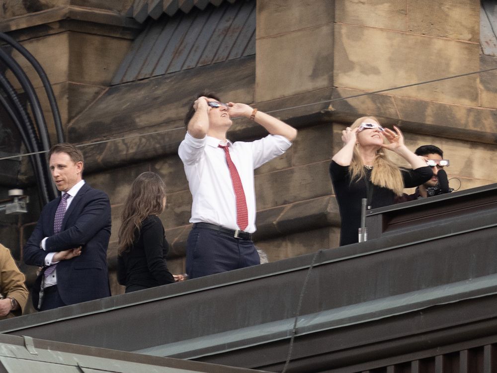 NextImg:MPs don eclipse glasses to take in ’surreal’ celestial event on Parliament Hill