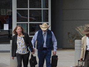 FILE - George Alan Kelly exits the Santa Cruz County Courthouse with defense attorney Kathy Lowthorp after the first day of his trial in Santa Cruz County Superior Court Friday, March 22, 2024 in Nogales, Ariz. Jurors in the case of the Arizona rancher Kelly charged with fatally shooting a migrant on his property visited the scene of the killing as the third week of the trial wrapped up. The jurors on Thursday, April 11, 2024, viewed various locations at Kelly's ranch, as well as a section of the U.S.-Mexico border.