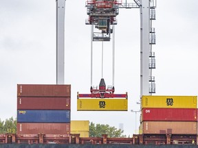 A shipping container is loaded onto a container ship in the Port of Montreal on Tuesday, Sept. 19, 2023.