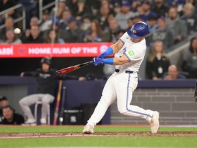 Toronto Blue Jays outfielder Daulton Varsho (25) hits a two-run homer driving in Davis Schneider during second inning American League MLB baseball action against New York Yankees pitcher Marcus Stroman in Toronto on Wednesday, April 17, 2024.