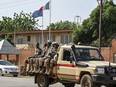 A patrol of the Niger national Police drives past the French Embassy in Niamey on August 28, 2023. Thousands of people demonstrated on August 27, 2023 in Niger in support of last month's coup, a few hours before the deadline given to France's ambassador in an ultimatum to leave the country. Demonstrators gathered near the French military base in the capital Niamey, some waving Nigerien or Russian flags, others with placards calling for the departure of French troops.