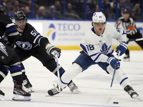 Toronto Maple Leafs right wing William Nylander (88) works around Tampa Bay Lightning left wing Austin Watson (51) and left wing Conor Sheary (73) during the first period of an NHL hockey game Wednesday, April 17, 2024, in Tampa, Fla.