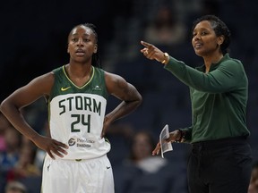 Seattle Storm guard Jewell Loyd (24) and head coach Noelle Quinn talk during the first half of a WNBA basketball game against the Minnesota Lynx, Tuesday, June 27, 2023, in Minneapolis. Quinn can't wait to bring the WNBA to Western Canada.