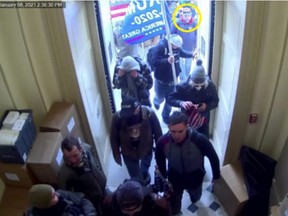 This image from U.S. Capitol Police video, contained and annotated in the Justice Department's sentencing memorandum for Gene DiGiovanni Jr., shows DiGiovanni, circled in yellow, entering the U.S. Capitol on Jan. 6, 2021, in Washington. The Connecticut business owner who has served as an elected alderman in his hometown was sentenced April 24, 2024, to 10 days behind bars for joining a mob's assault on the U.S. Capitol over three years ago, court records show.(Department of Justice via AP)