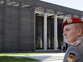 FILE - A soldier is seen in front of the 'Military Memorial of the German Bundeswehr' in Berlin Germany, Tuesday, Sept. 8, 2009. The German parliament voted Thursday for the introduction of an annual national "veterans' day" to honor the service of people who have served in the military, which often has struggled to gain recognition in the country.