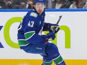 Vancouver Canucks' Quinn Hughes watches the puck as he skates during the first period of an NHL hockey game against the Calgary Flames in Vancouver, on Tuesday, April 16, 2024.