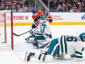 San Jose Sharks goalie Georgi Romanov (31) is scored on by Edmonton Oilers' Zach Hyman (18) as Jack Thompson (26) defends during second period NHL action in Edmonton on Monday April15, 2024.
