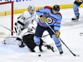 Los Angeles Kings' Matt Roy (3) gets tangled up with Winnipeg Jets' Nino Niederreiter (62) in front of Kings goaltender Cam Talbot (39) during the third period of NHL action in Winnipeg on Monday April 1, 2024.