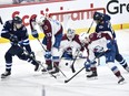 Colorado Avalanche goaltender Alexandar Georgiev (40) makes a save on a shot as Winnipeg Jets' David Gustafsson (19) and Alex Iafallo (9) look for the rebound during the first period in Game 2 of their NHL hockey Stanley Cup first-round playoff series in Winnipeg, Tuesday April 23, 2024.