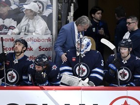 Winnipeg Jets' head coach Rick Bowness speaks with goaltender Connor Hellebuyck (37) after he was pulled for the extra attacker at the end of the third period against the Colorado Avalanche in Game 2 of their NHL hockey Stanley Cup first-round playoff series in Winnipeg, Tuesday April 23, 2024. Rick Bowness always goes to bed with hockey looping in his mind, but Tuesday night's thoughts weren't all bad for the Winnipeg Jets head coach.