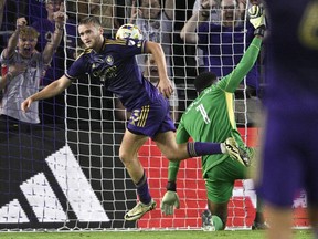 Orlando City forward Duncan McGuire (13) starts to celebrate a goal against Toronto FC goalkeeper Sean Johnson (1) during the first half of an MLS soccer match, Saturday, April 27, 2024, in Orlando, Fla.