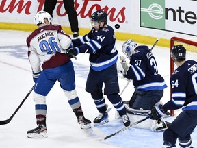 Connor Hellebuyck made sure he did one important thing while winding down Sunday after the Winnipeg Jets beat the Colorado Avalanche 7-6 in Game 1 of their first-round playoff series. Hellebuyck (37) makes as save as teammate Josh Morrissey (44) checks Colorado Avalanche right wing Mikko Rantanen (96) during first period NHL hockey Stanley Cup first-round playoff series Game 1 action, in Winnipeg, Sunday April 21, 2024.