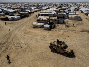 FILE - Kurdish forces patrol al-Hol camp, which houses families of members of the Islamic State group in Hasakeh province, Syria, on April 19, 2023. Iraq has repatriated hundreds more of its citizens linked to the Islamic State group from a sprawling camp in northeastern Syria, Iraqi and Syrian officials said Monday, April 29, 2024.