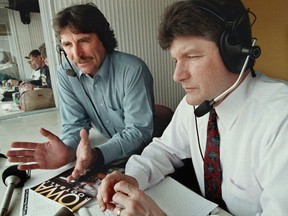 FILE - University of Iowa football radio color commentator Ed Podolak, left, works with play-by-play announcer Gary Dolphin before the Iowa spring football game, April 19, 1997, in Iowa City, Iowa. Longtime Iowa football broadcaster Ed Podolak has announced he will move out of the radio booth this season and limit his appearances to pregame shows and podcasts. Podolak played quarterback and running back for the Hawkeyes before he became a fixture at running back for the Kansas City Chiefs from 1969-77. Podolak was a color commentator for NBC and ESPN before he joined the Iowa radio broadcast crew in 1982.