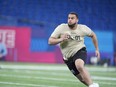 Illinois offensive lineman Isaiah Adams runs a drill at the NFL football scouting combine, Sunday, March 3, 2024, in Indianapolis.