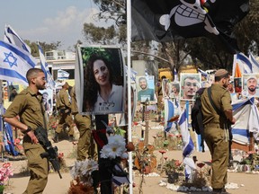 Israeli soldiers visit a memorial