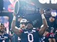 Montreal Alouettes defensive end Shawn Lemon (0) hoists the Grey Cup as the Alouettes celebrate defeating the Winnipeg Blue Bombers in the 110th CFL Grey Cup in Hamilton, Ont., on Sunday, November 19, 2023. Lemon, who won three Grey Cups with three different organizations, announced his retirement from the Canadian Football League on Wednesday.