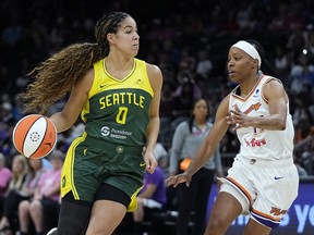 Seattle Storm guard Kia Nurse (0) dribbles the ball against Phoenix Mercury guard Shey Peddy during the first half of a WNBA basketball game Saturday, Aug. 5, 2023, in Phoenix. When Kia Nurse was growing up in Hamilton, the nearest professional basketball that she could see in person was the Toronto Raptors and although superstar Vince Carter was her favourite player, she couldn't see herself in him.