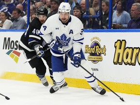 Toronto Maple Leafs' Auston Matthews (34) protects the puck from Tampa Bay Lightning's Nick Perbix (48) during first period NHL hockey action in Tampa, Fla. on Wednesday, April 17, 2024.