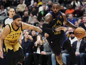 Los Angeles Lakers forward LeBron James (23) drives past Toronto Raptors forward Bruce Brown (11) during second half NBA basketball action in Toronto on Tuesday, April 2, 2024.