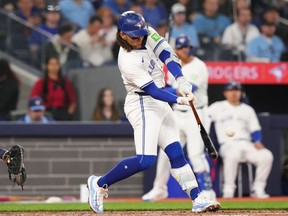 Toronto Blue Jays' Bo Bichette (11) hits a two-run home run against the Seattle Mariners during third inning American League MLB baseball action in Toronto on Tuesday, April 9, 2024.