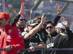 Sauber driver Zhou Guanyu, right, of China and teammate Valtteri Bottas of Finland wave during the drivers parade ahead of the Australian Formula One Grand Prix at Albert Park, in Melbourne, Australia, Sunday, March 24, 2024.