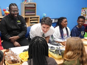 Prime Minister Justin Trudeau talking to a group of children.