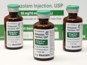 FILE - This July 25, 2014 photo shows vials of the sedative midazolam at a hospital pharmacy in Oklahoma City. An investigation led by The Associated Press published in 2024, has found the practice of giving sedatives to people detained by police spread quietly over the last 15 years, built on questionable science and backed by police-aligned experts. (AP Photo/File)