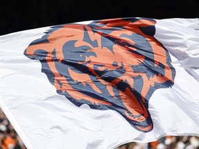 FILE - The Chicago Bears logo is pictured on a flag prior to an NFL football game between the Chicago Bears and Denver Broncos, Oct. 1, 2023, in Chicago. The Chicago Bears have scheduled a Wednesday, April 24, 2024, news conference to announce plans for "a state-of-the-art, publicly owned enclosed stadium" on the city's Museum Campus near Lake Michigan. The announcement Monday, April 22, said the plans also call for additional green and open space with access to the lakefront.