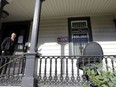 FILE - A person stands on the porch of the international headquarters of the Satanic Temple in Salem, Mass., Oct. 24, 2016. An Oklahoma man was arrested Wednesday, April 17, 2024, after authorities accused him of throwing a pipe bomb at the building last week.