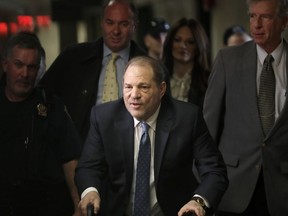 FILE - Harvey Weinstein arrives at a Manhattan courthouse for jury deliberations in his rape trial, Monday, Feb. 24, 2020, in New York. New York's highest court has overturned Harvey Weinstein's 2020 rape conviction and ordered a new trial.