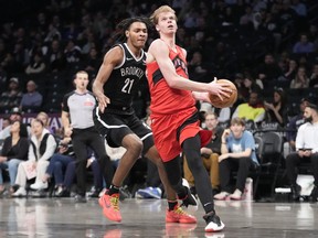 Gradey Dick's rookie season got off to a rough start as he struggled to put up numbers in his limited time with the Toronto Raptors. But advice that his parents gave kept him focused and motivated. Dick, foreground, drives to the basket past Brooklyn Nets forward Noah Clowney (21) during second half NBA basketball action, in New York, Wednesday, April 10, 2024.