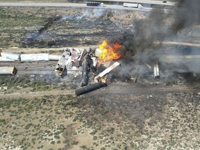 In this photo provided by David Yellowhorse, a freight train carrying fuel derailed and caught fire, Friday, April 26, 2024, east of Lupton, Ariz., near the New Mexico-Arizona state line. Authorities closed Interstate 40 in both directions in the area, directing trucks and motorists to alternate routes.