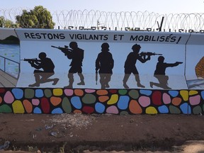 FILE - A mural is seen, March 1, 2023, in Ouagadougou, Burkina Faso. Military forces in Burkina Faso killed 223 civilians, including babies and many children, in attacks on two villages accused of cooperating with militants, Human Rights Watch said in a report published Thursday, April 24, 2024. (AP Photo, File)