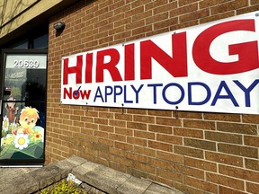 FILE - A hiring sign is displayed in Riverwoods, Ill., Tuesday, April 16, 2024. The Biden administration has finalized a new rule set to make millions of more salaried workers eligible for overtime pay in the U.S. The move marks the largest expansion in federal overtime eligibility seen in decades.
