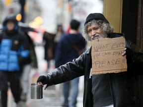 A man panhandling in Toronto.